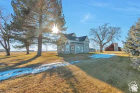 Traditional-style residence with light-toned siding and dark trim