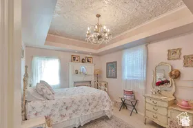 Tray ceiling with a decorative ceiling tile inlay and a crystal chandelier