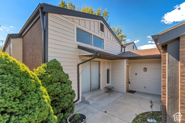 Siding exterior with brick accents and dark trim