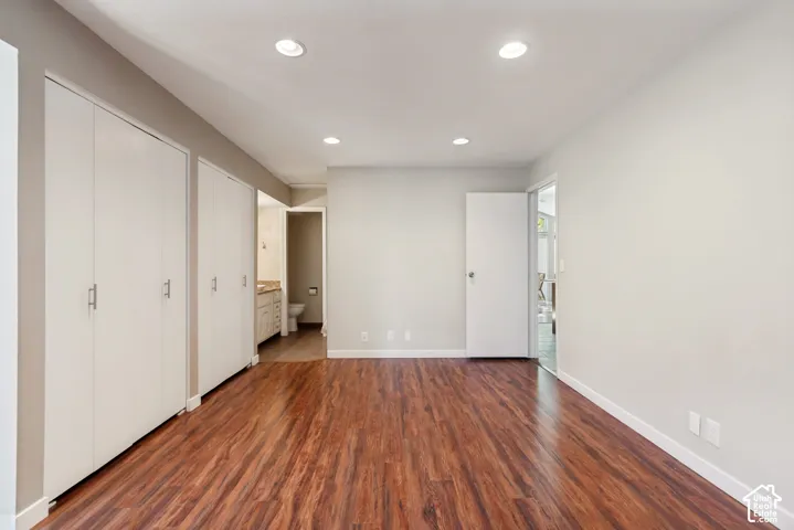 Wood-finish flooring throughout, recessed lighting, and white walls