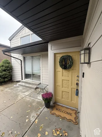 Yellow paneled front door with decorative carving