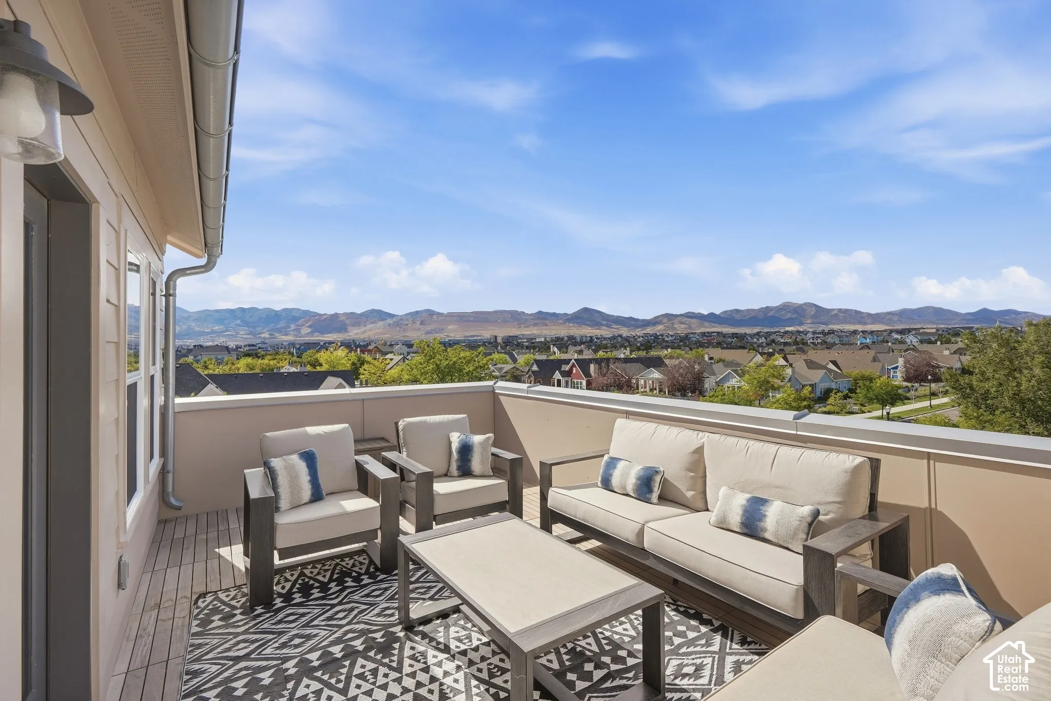 Expansive outdoor terrace featuring wood-finish decking and a sturdy perimeter railing