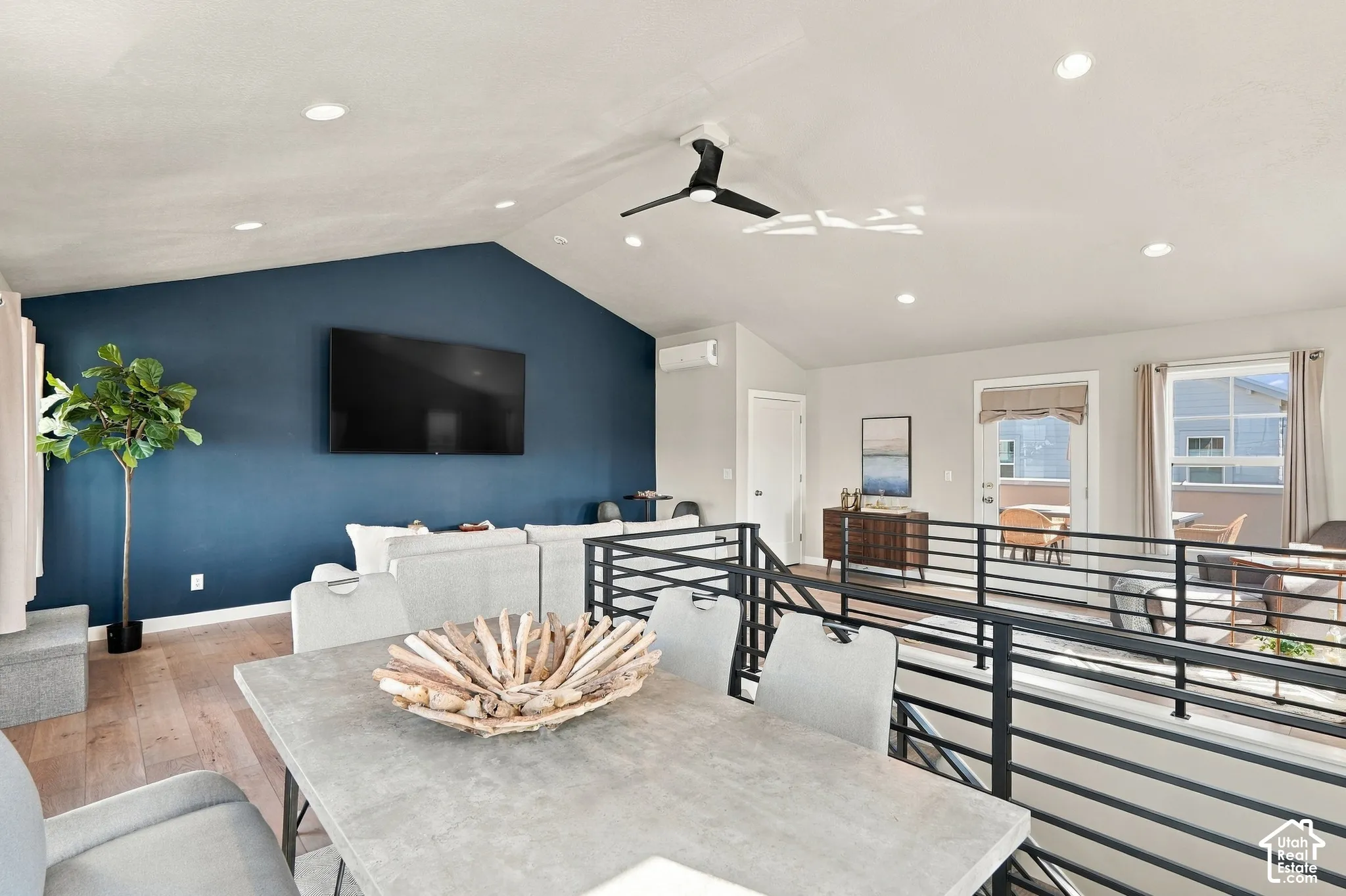 Vaulted ceiling with recessed lighting and a ceiling fan