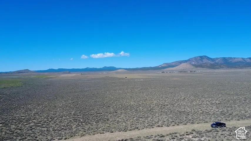 Expansive arid landscape with distant mountains under a clear sky
