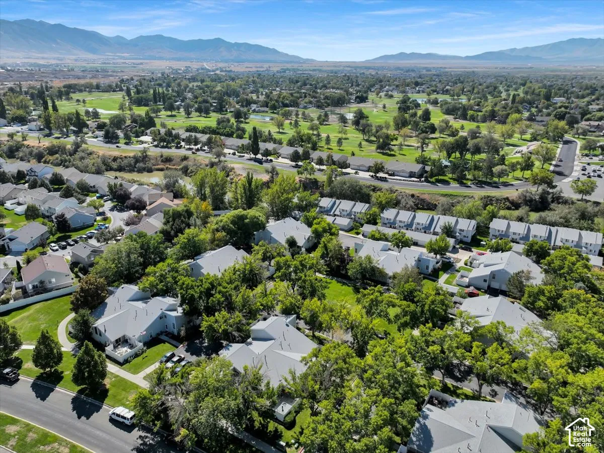 Expansive green spaces and mature trees surround residential structures