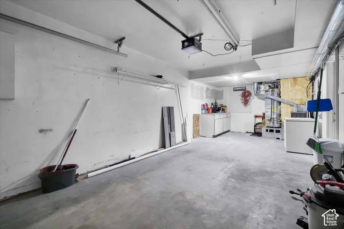 Concrete flooring with exposed ceiling utilities and fluorescent lighting