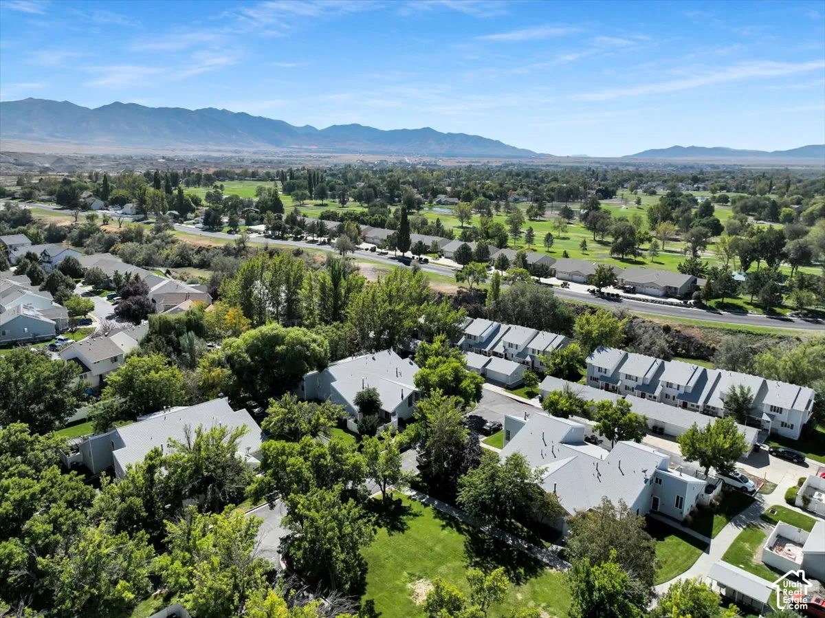 Aerial view showcasing a contemporary residential community nestled within expansive landscaped grounds