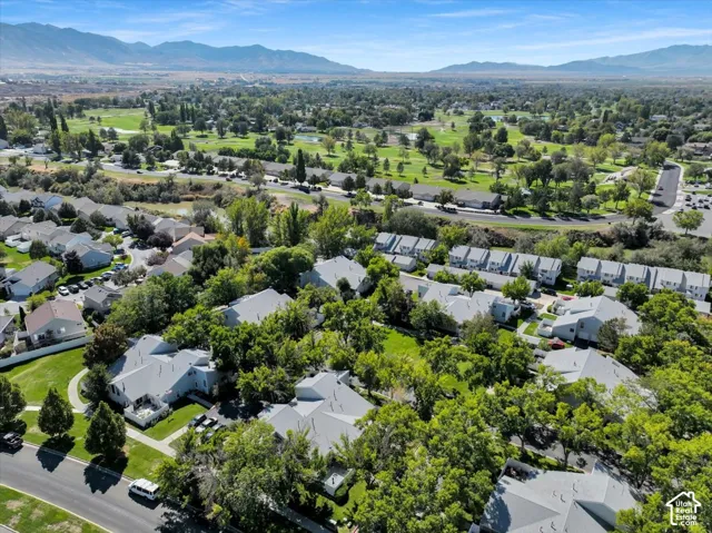 Expansive green spaces and mature trees surround residential structures