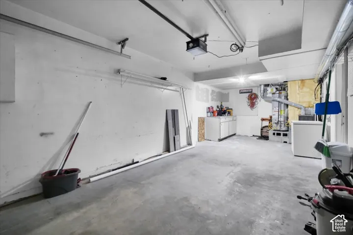 Concrete flooring with exposed ceiling utilities and fluorescent lighting