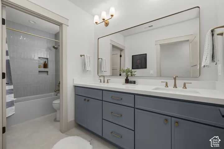 Double vanity with white countertops, undermount sinks, and bronze-finish fixtures