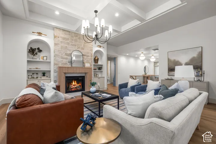 Recessed lighting, a coffered ceiling, and wood-finish flooring enhance this living space
