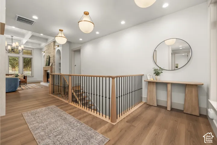 Wood-finish flooring with a coordinating wood and iron baluster railing