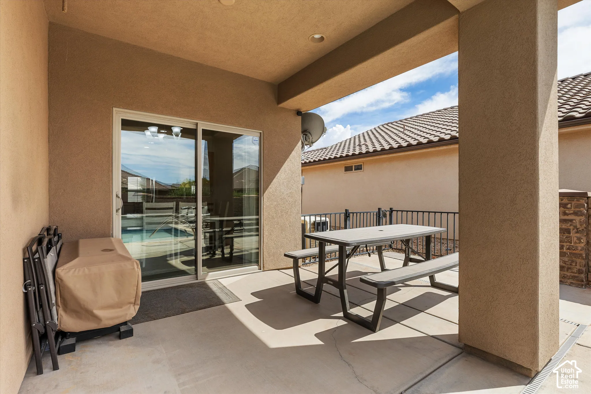 Covered patio with concrete flooring, recessed lighting, and a sliding glass door