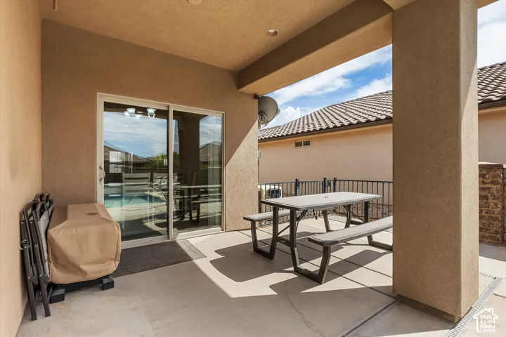 Covered patio with concrete flooring, recessed lighting, and a sliding glass door