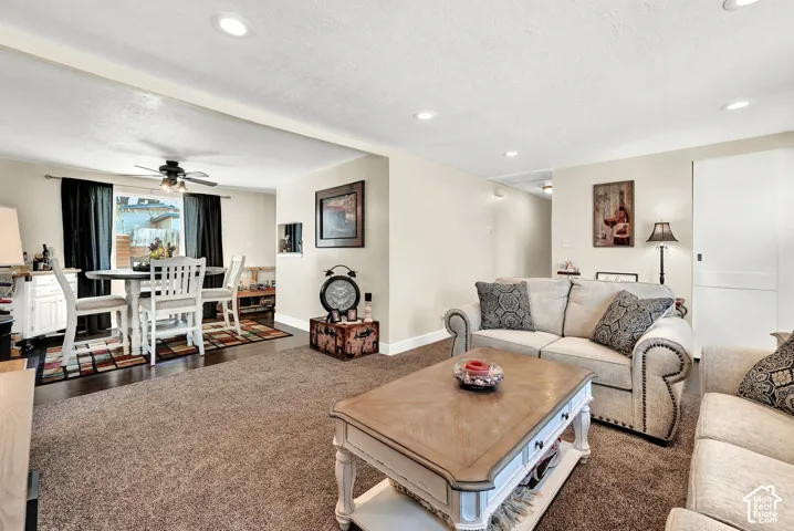 Recessed lighting illuminates neutral-toned walls and plush carpeting