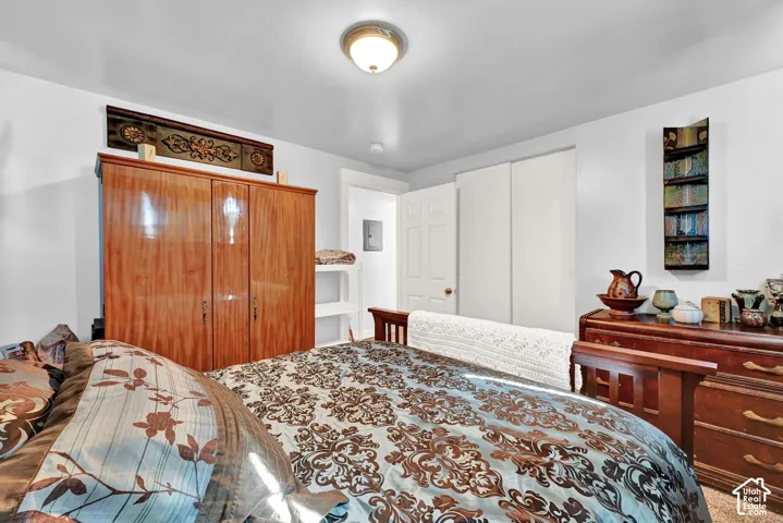 White walls, overhead lighting, and built-in closet with sliding doors