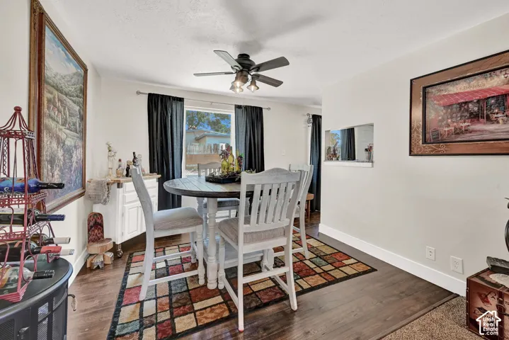 Wood-finish flooring throughout, complemented by a ceiling fan with integrated lighting