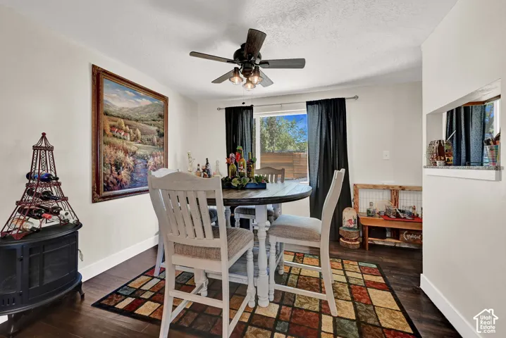 Hardwood-finish flooring, recessed ceiling, ceiling fan with integrated lighting, and a pass-through window with a granite countertop