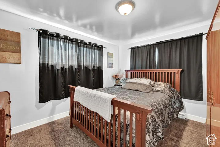 Light-colored walls with crown molding, recessed lighting, and soft carpet flooring