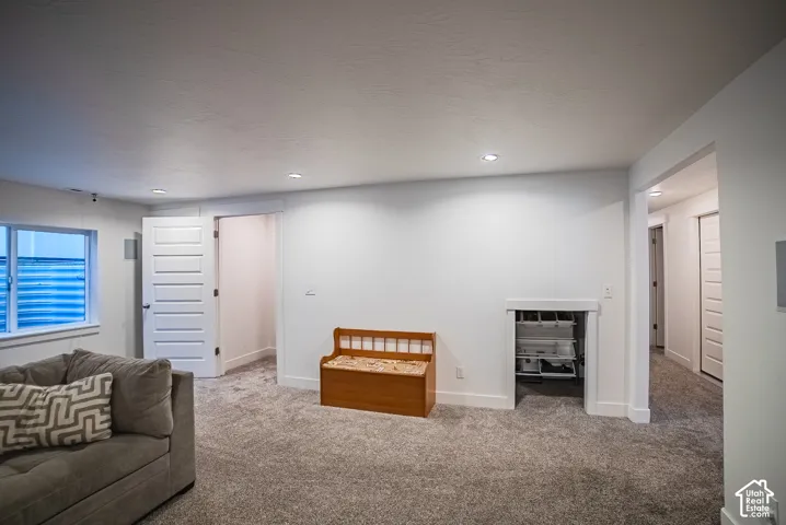 Recessed lighting, wall-to-wall carpeting, white interior doors, and a built-in storage niche