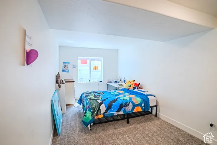 Recessed window, white walls, and gray carpet flooring