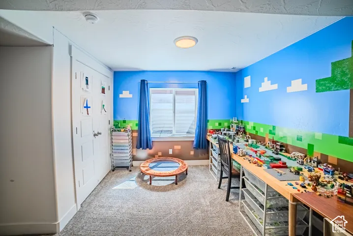 Carpeted flooring, built-in desk area, recessed lighting, double closet doors, and window with blinds