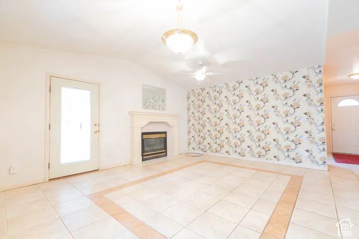 Vaulted ceiling with an attached ceiling fan and pendant light