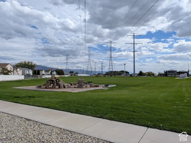 Expansive green space featuring a concrete walkway and gravel border