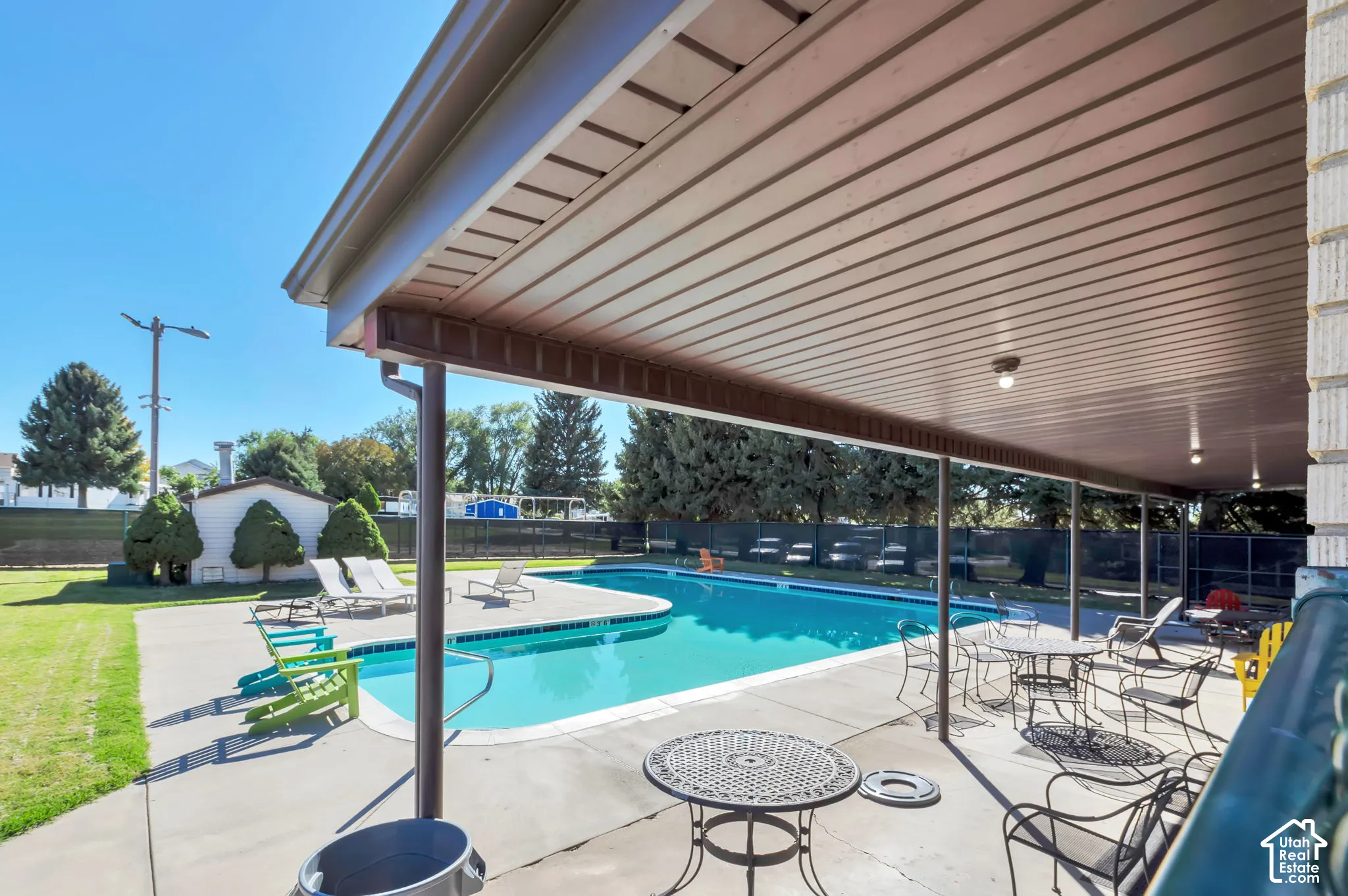 Expansive outdoor swimming pool with surrounding concrete patio