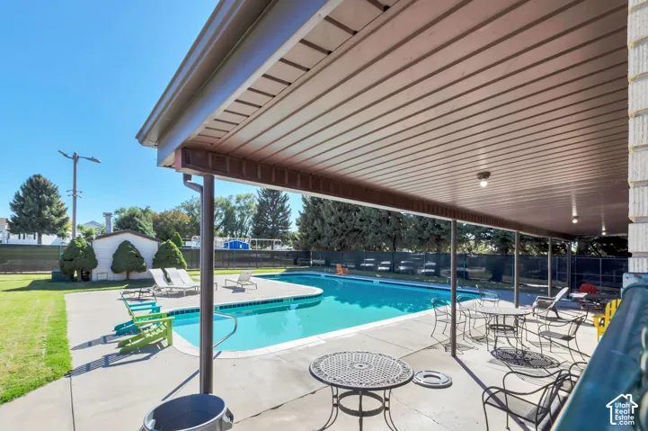 Expansive outdoor swimming pool with surrounding concrete patio