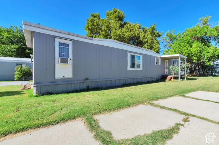 Gray exterior siding with white trim, multiple windows, and a covered porch