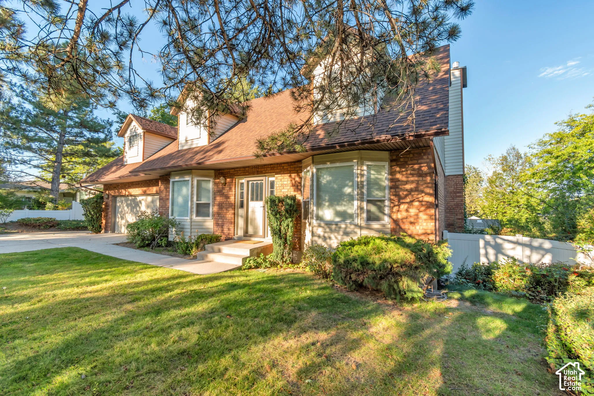 Brick exterior with dormer windows and an attached garage