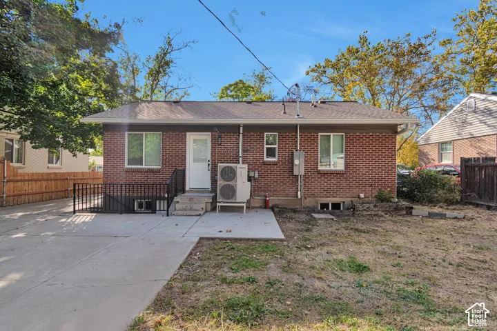 Brick exterior, concrete patio, and a privacy fence