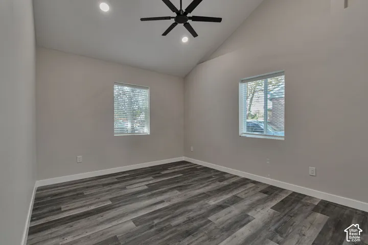 Vaulted ceiling with a black ceiling fan, recessed lighting, and wood-finish flooring
