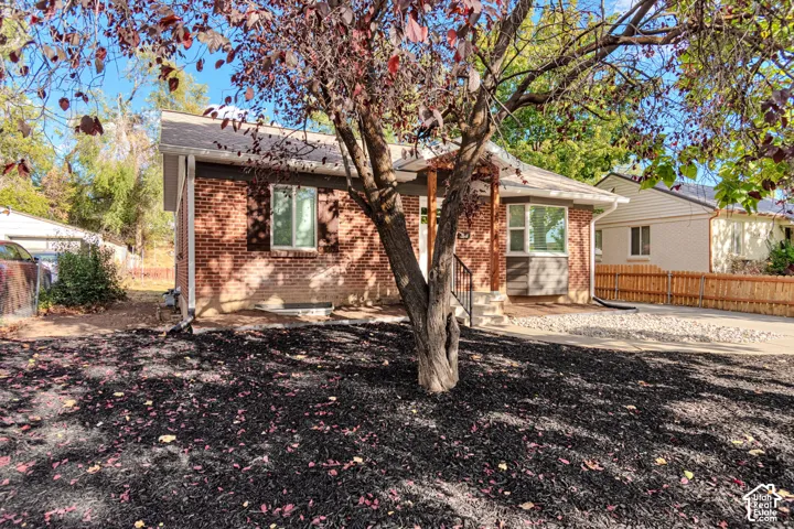 Brick exterior with a covered entry, established landscaping