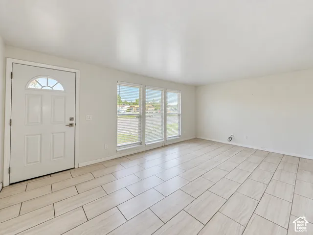 White paneled entry door with fan-light transom