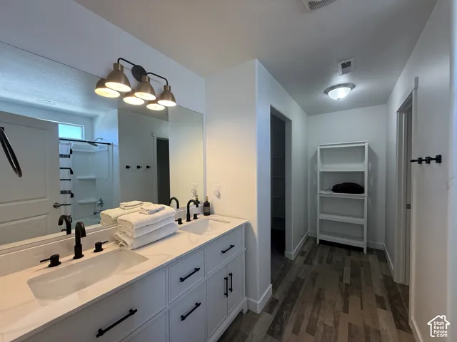 Dual vanity with integrated sinks, matte black fixtures, and white cabinetry