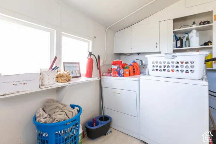 Laundry area with white cabinetry, built-in shelving, and a utility sink