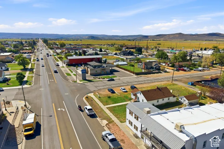 Aerial perspective of a commercial district with paved roads, streetlights, and multiple commercial buildings