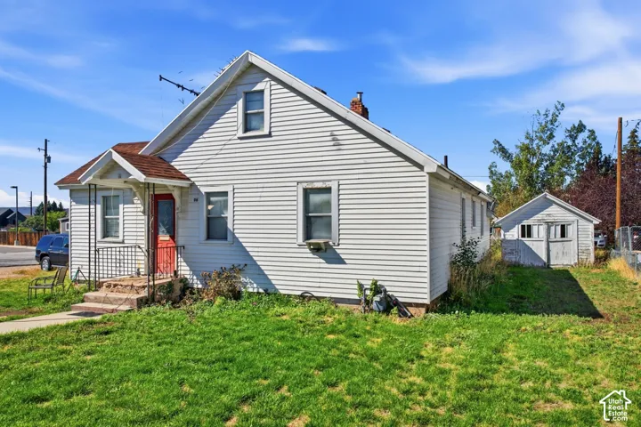 White horizontal siding exterior with a pitched roof and a red front door