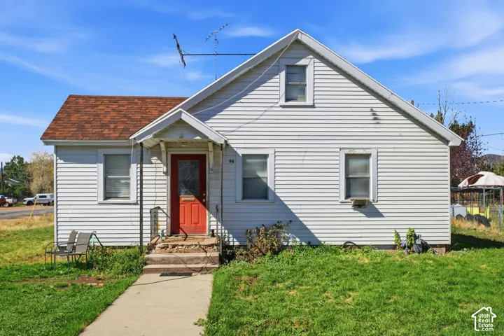 White horizontal siding exterior with a red front door, a covered entry, and a brown shingled roof