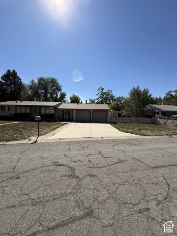 Single-story residence with a light-colored exterior and a dual-car garage
