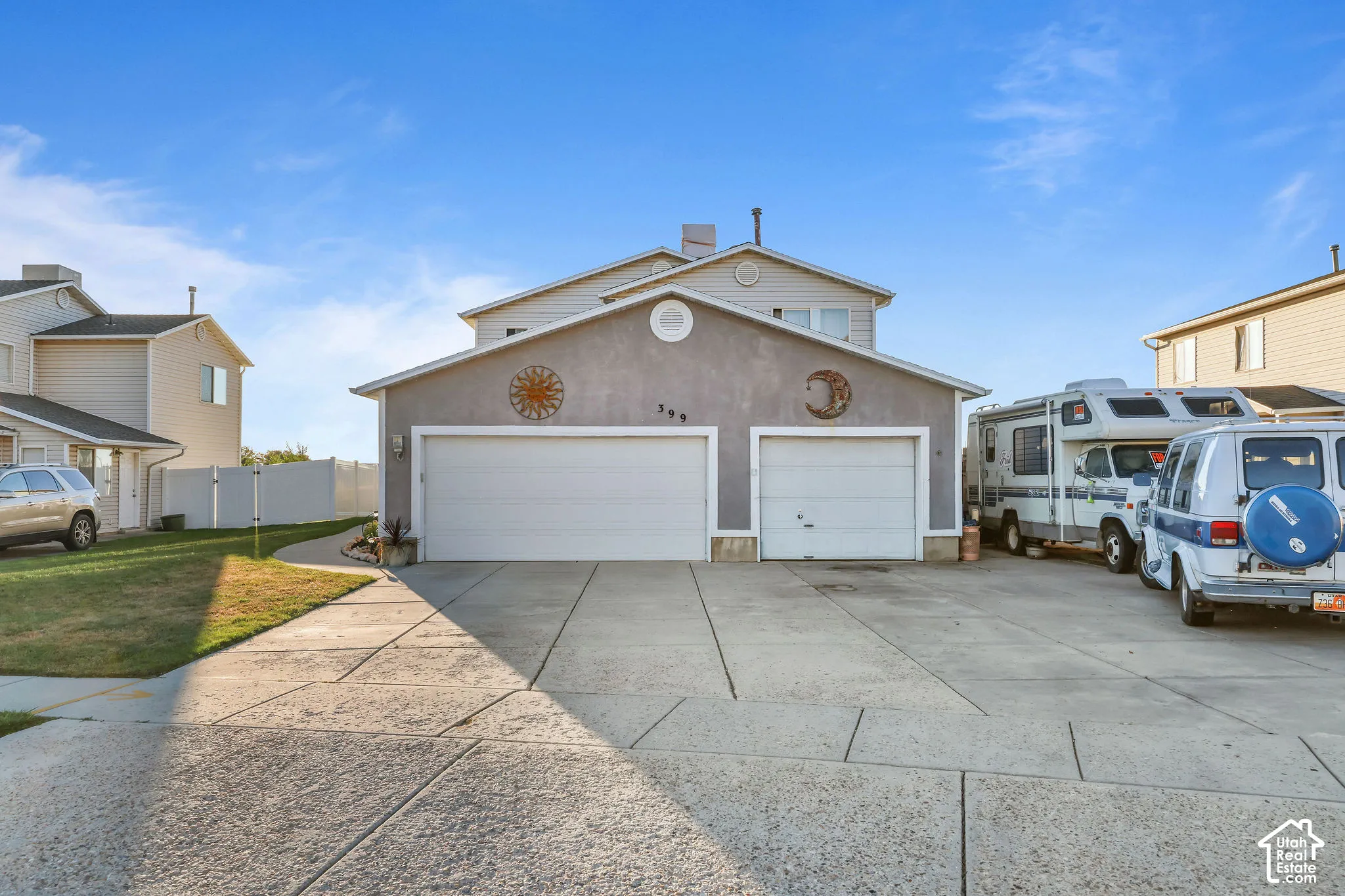 Two-car garage with overhead doors and a concrete driveway