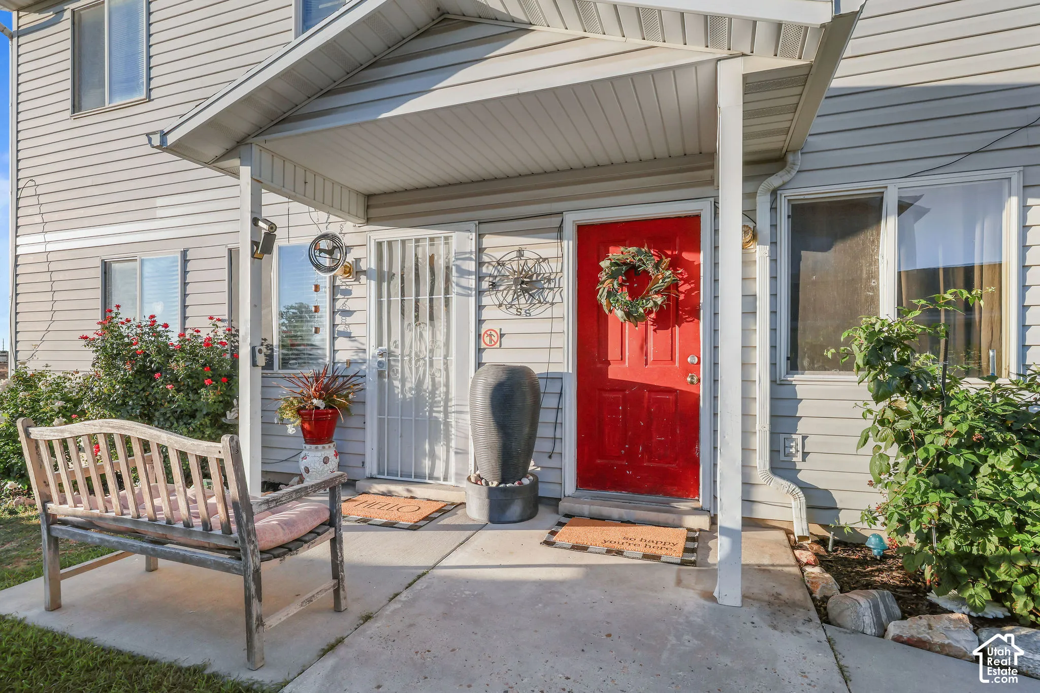 Covered porch entry featuring a bold red door