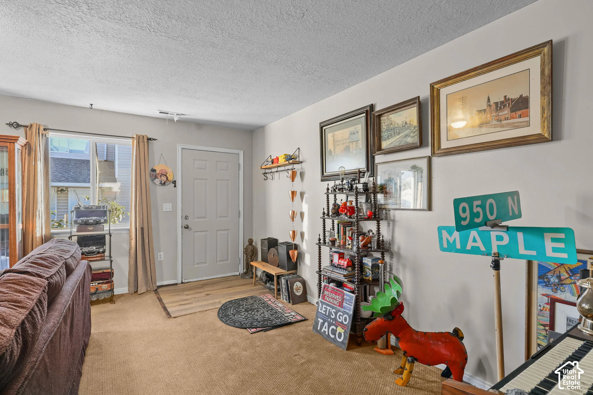 Unit B, Entryway with a solid-panel door, carpeting, and a window with trim