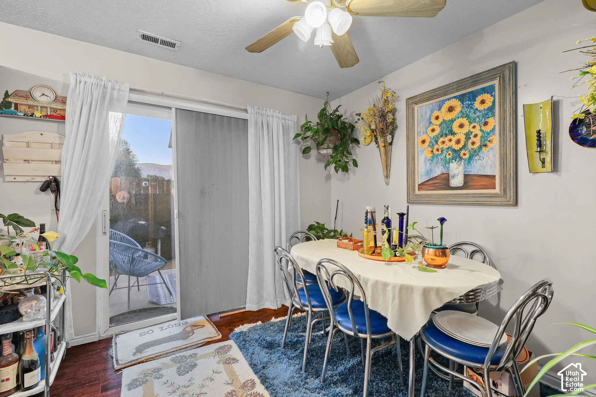 Unit A, Sliding glass door, wood-finish flooring, ceiling fan with integrated lighting, wall-mounted shelving