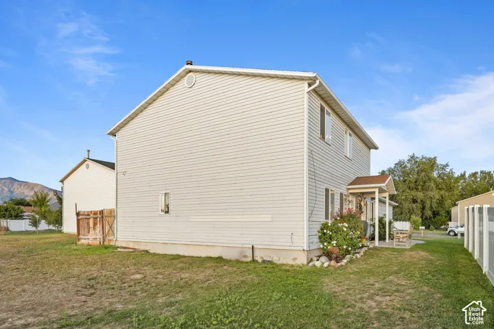 Two-story residence featuring light-colored siding and a covered entry