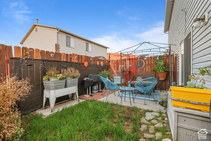 Unit A, Private fenced yard with concrete and stone patio areas