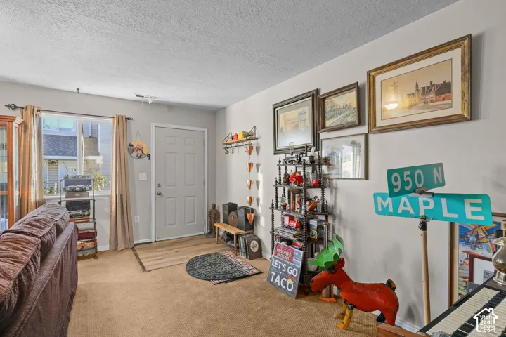 Unit B, Entryway with a solid-panel door, carpeting, and a window with trim