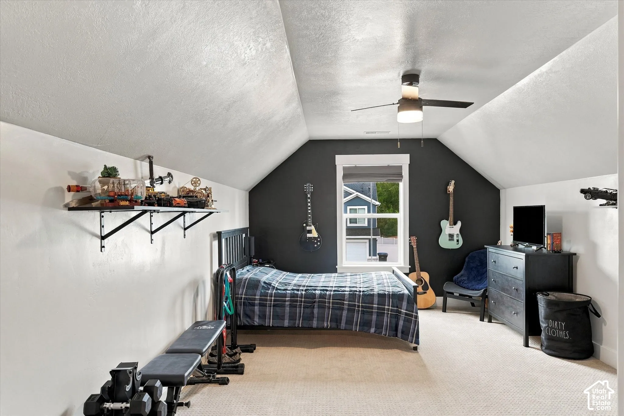 Carpeted flooring, vaulted ceiling, ceiling fan, and a single window
